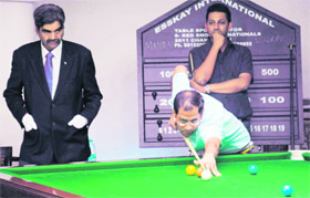 Saurav Kothari plays a shot as his opponent Manan looks on during the 6-Red National Snooker at Chandigarh Club on Monday. 