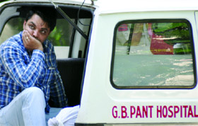 Anil Malik, son of Rajbala (right), mourns near the body in the mortuary of G B Pant Hospital, New Delhi, on Monday.
