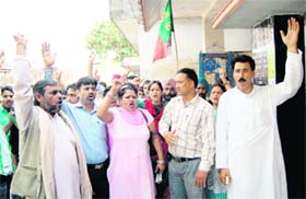 Uttarakhand Kranti Dal (P) workers hold a protest in front of the office of the Assistant Labour Commissioner in Dehradun on Monday