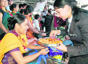 Students welcome tourists at the Shimla railway station on Monday.