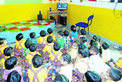 Schoolchildren watch a movie on the Martyrs Day at Shemrock Mehars School in Kurukshetra.