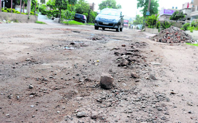 A dilapidated road in Sector 13 in Karnal. With the monsoon taking a heavy toll on roads in the city, locals have urged the authorities to carry out immediate repairs.