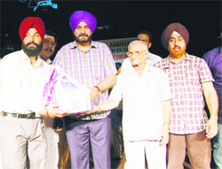 MP Navjot Singh Sidhu (second from left) distributes sports kits among various youth clubs during the Youth Convention at Virsa Vihar in Amritsar on Monday. 