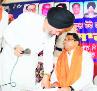 BSP MPs Narinder Kashyap and Avtar Singh Kareempuri discuss a point in Amritsar on Monday. 