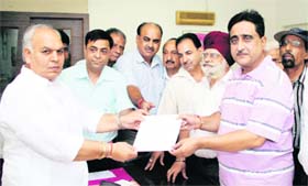 Members of the Beopar Sena Punjab give a memorandum to MP Mohinder Singh Kaypee at his residence in Jalandhar on Monday