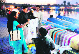 Tourists shop along Srinagars Dal Lake. Over 10 lakh tourists have visited Kashmir so far this year.  AFP