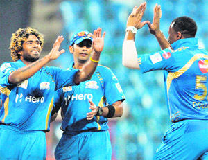 Mumbai Indians Lasith Malinga (L) celebrates with his teammates during the CLT20 match against Trinidad and Tobago in Bangalore on Monday.