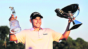 Bill Haas holds aloft the FedEx Cup and the Tour Championship trophy in Atlanta on Monday.