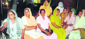 (Extreme left) Bhajno, the mother of the deceased, at the police station in Shahkot on Tuesday.