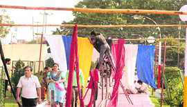 Workers give the finishing touches to a pandal outside the Kali temple in Jammu