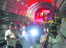 Rescuers evacuate passengers after a subway train collision in Shanghai. 