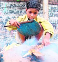 A young child sells roasted maize on the street in Amritsar. 
