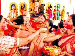 Women apply vermilion on each other during Durga Puja celebrations at Sector 5, Panchkula