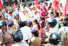Workers of the CPM, who were proceeding towards the state Assembly, are stopped by the police in Dehradun on Wednesday. 