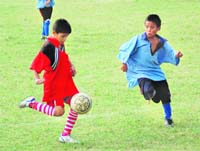Players of Carman School (in red) and Morovian School (in blue) in action in a match in the Inter-Council School Sub-Junior Boys Football Tournament in Dehradun on Wednesday.