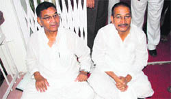 Mahinder Singh Mahra and Kishore Upadhyay, Congress MLAs, stage a dharna in the Uttarakhand Assembly building, Dehradun, on Wednesday. 