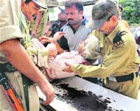 An injured woman being taken to a hospital after the bus she was travelling in overturned in Jammu on Wednesday.