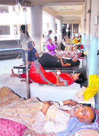 Patients lie on beds in a veradah of the Civil Hospital in Jalandhar on Wednesday
