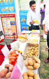 A person shows products made from potatoes at an exhibition in Ludhiana