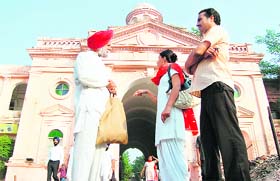 Two guides accompany tourist Mohinder Singh during the heritage walk in Amritsar on Thursday