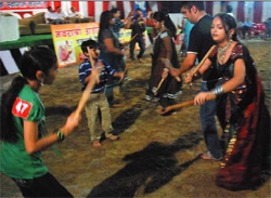 Local residents play dandiya at the SSD Sabha Temple opposite Gol Diggi on the onset of Navratras in Bathinda late on Wednesday night