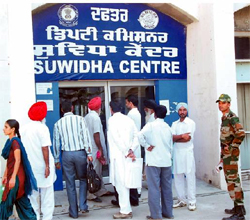 Visitors stand at the main gate of the closed Suvidha Centre in Bathinda on Thursday