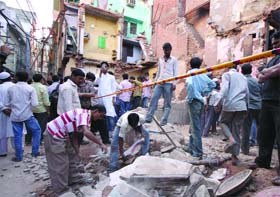 Locals on Thursday help the relief and rescue team in removing the debris of the building that collapsed in Chandni Mahal in Old Delhi on Tuesday.