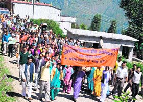Residents of villages across the Gori river hold a procession at Munsiyari town on Thursday