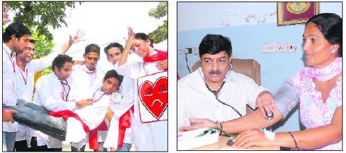 A street play organised by a youth group to spread awareness on heart disorders; and (right) Dr Balraj Gupta, cardiologist, Rattan Hospital, checks patients during a health camp organised at the Punjab Press Club to mark World Heart Day in Jalandhar on Thursday. 