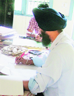 A patwari prepares a farad at Patwar Khana of Jodhan village in Ludhiana on Thursday