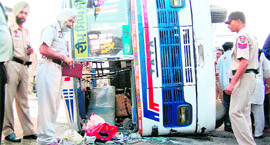 Police personnel conduct an investigation at the accident site  on Friday.