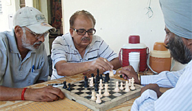Senior citizens play a game of chess at the home for the elderly in the city on Friday.