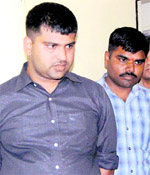 Tarun Kumar Jha (left), who was arrested by the Dehradun police for allegedly posing as an official of the Railways on Friday.