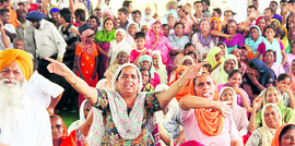 Villagers protest against the setting up of a solid waste treatment plant at Pholariwal village during a public hearing in Jalandhar on Friday.