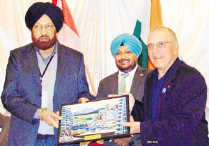 Mayor Hakam Singh Giaspura receives a memento from his Abbotsford counterpart George W Peary. A Tribune photograph