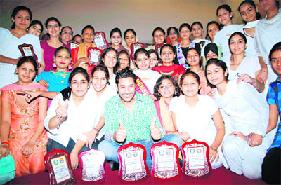 Winner of PU Zonal Youth Fest with Harbhajan Mann at Ramgarhia Girls College in Ludhiana on Friday.