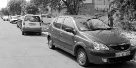 Vehicles parked in front of houses.