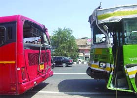 A DTC low-floor red bus and an old DTC bus are parked after a collision near Rajouri Garden in west Delhi on Saturday