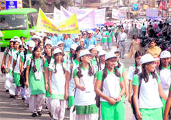Schoolgirls participate in a march held on the occasion of Voluntary Blood Donation Day in Dehradun on Saturday
