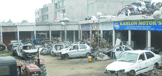 PUDA Complex on the Ladowali Road with many defunct cars and heaps of spare parts.