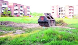 A garbage bin lies right in the middle of a park in the residential area of the PGI, Sector 14