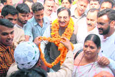 Ramesh Pokhriyal Nishank being welcomed by supporters on his arrival in Dehradun on Sunday.
