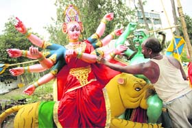 An artisan gives final touches to an idol of Godess Durga in Jalandhar on Sunday