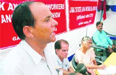 A speaker addresses a convention on anganwadi workers in Jammu on Sunday. 