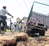 A Truck stuck in a road cave-in at Ishar Nagar in Ludhiana on Sunday.