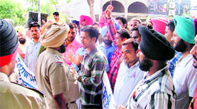 Members of the Berozgar Multipurpose Health Workers Union argue with police officials in Ludhiana on Sunday.