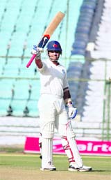 Rest of Indias Ajinkya Rahane raises his bat after completing his century against Rajasthan in Jaipur. 