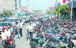 A view of the vehicles parked in a haphazard manner on the Guru Kashi Marg in the city on Monday.