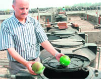 A resident shows buoys after valves attached to them were stolen from overhead water tanks in Sector 51.