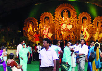 Devotees celebrate Durga Puja at Chittaranjan Park in New Delhi on Monday. 